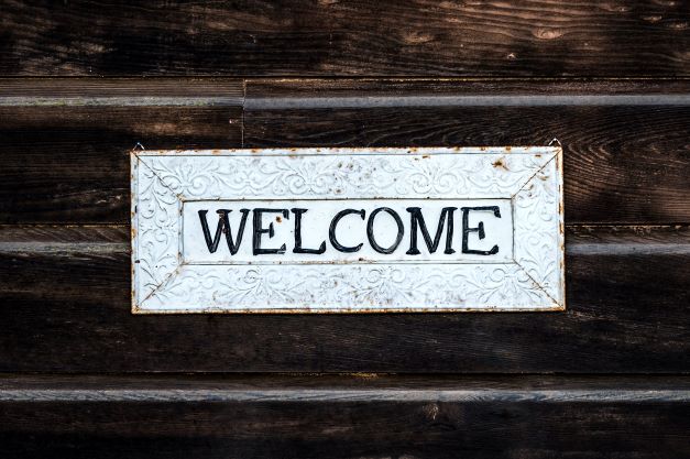 A welcome sign against dark timber